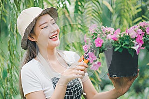 Young women doing hobbies taking care of plants, watering, shoveling flowers. In the garden during the break from work