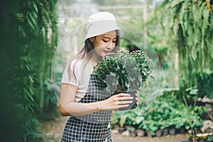 Young women doing hobbies taking care of plants, watering, shoveling flowers. In the garden during the break from work