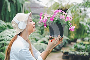 Young women doing hobbies taking care of plants, watering, shoveling flowers. In the garden during the break from work