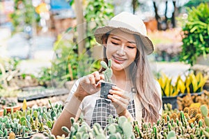 Young women doing hobbies taking care of plants, watering, shoveling flowers. In the garden during the break from work