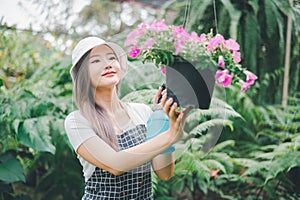 Young women doing hobbies taking care of plants, watering, shoveling flowers. In the garden during the break from work