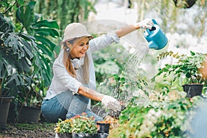 Young women doing hobbies taking care of plants, watering, shoveling flowers. In the garden during the break from work