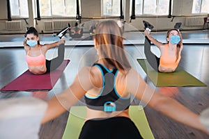 Young women doing push up exercise in room during morning