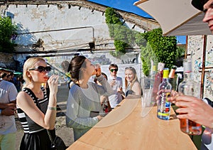 Young women drinking wine in outdoor bar