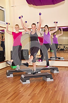 Young women exercising aerobics in gym