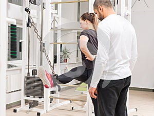 Woman exercising legs on cable crossover machine