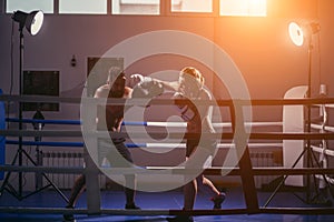 Woman exercising with trainer at boxe and self defense lesson. Copy space photo