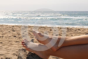 young women feet, relaxing on the beach
