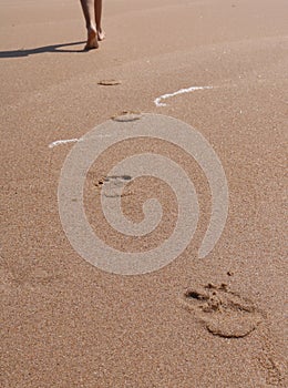 young women feet, relaxing - walking on the beach