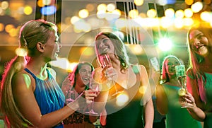 Young women with glasses of champagne in club