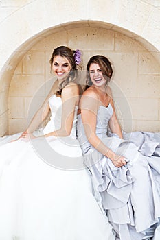 Young Women in Gowns and Sitting in an Alcove