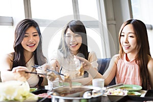 Young Women group Eating hot pot