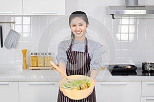 Young women are happy in the modern kitchen with healthy food, healthy food ideas and weight loss, copy space