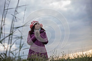 Young women are happy the winter in garden