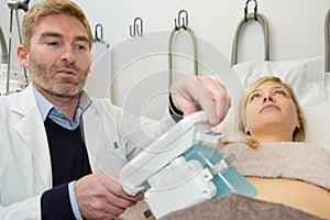 Young woman having cool sculpting therapy photo