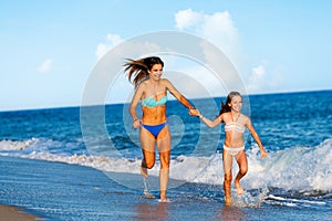 Young women having fun along beach.