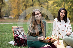 Young women having a fun picnic at the park