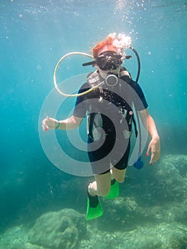 Young women having scuba diving .