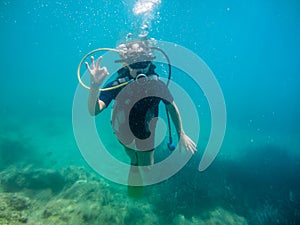 Young women having scuba diving  into the mediteranean sea