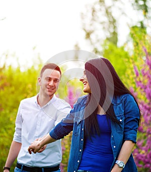 Young woman holding man`s hand