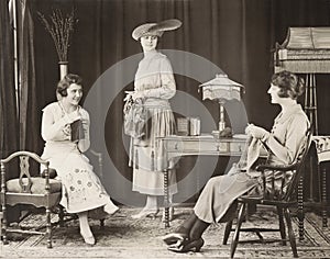 Young women knitting at home photo