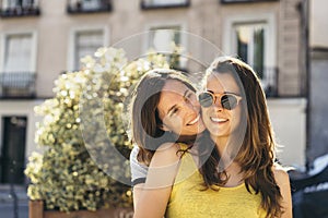 Young women lesbian women couple hugging