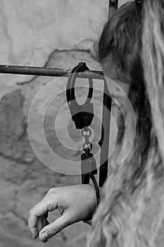 Young women locked with handcuffs to radiator