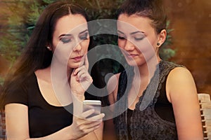 Young Women Looking at Smart Phone Screen