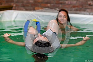 Pregnant woman relaxing in swimming pool