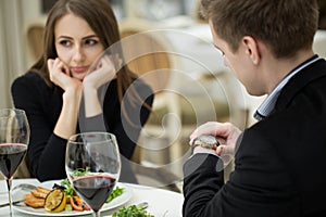 Young woman making an exasperated expression gesture on a bad date at the restaurant.