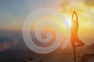 Young women meditate while doing yoga meditation, spiritual mental health practice with silhouette of lotus pose having peaceful