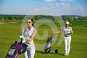 Young women and men playing golf