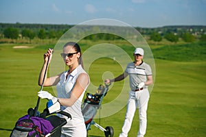 Young women and men playing golf
