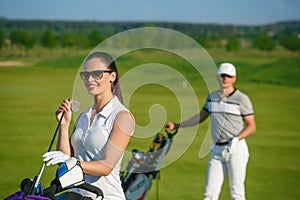 Young women and men playing golf