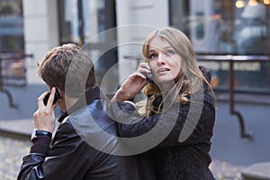 Young women and men talking on mobile phone