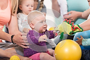 Young women in mother and child group playing with their baby kids