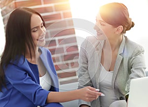 Young women in office working together on desktop