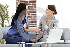 Young women in office working together on desktop