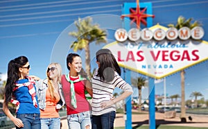 Young women over welcome to las vegas sign
