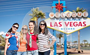 Young women over welcome to las vegas sign