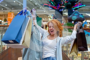 Young Women with Packages Shopping in Modern Mall. Shopping Concept. Black Friday Concept. Happy Women. Holding Packages