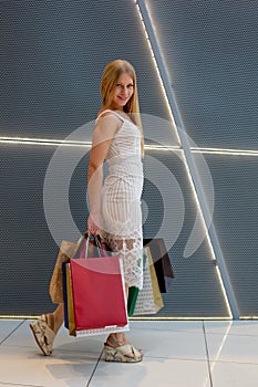 Young Women with Packages Shopping in Modern Mall. Shopping Concept. Black Friday Concept. Happy Women. Holding Packages