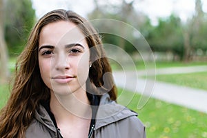 Young women poses outdoors in a park