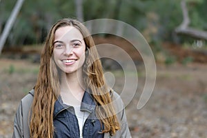 Young women poses outdoors smiling