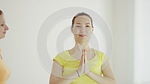 Young women are practicing yoga indoors