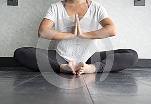 Young women practising yoga in butterfly position - Namaste