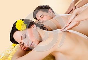 Couple Receiving Shoulder Massage At Spa
