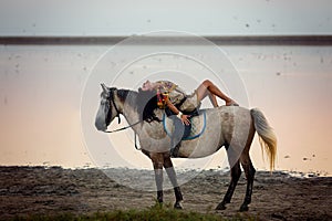 Young women riding a horse
