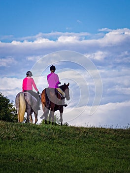 Two Young Women Riding Horses