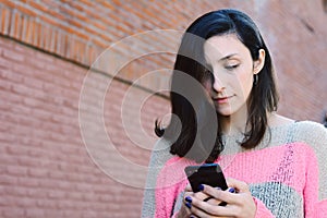 Young women sending message with smartphone.